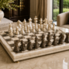 Top view of marble chess board with white and dark marble chess pieces arranged for play.