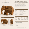 Hand-carved wooden Jaipur elephant displayed on a table with luxury home decor accessories.